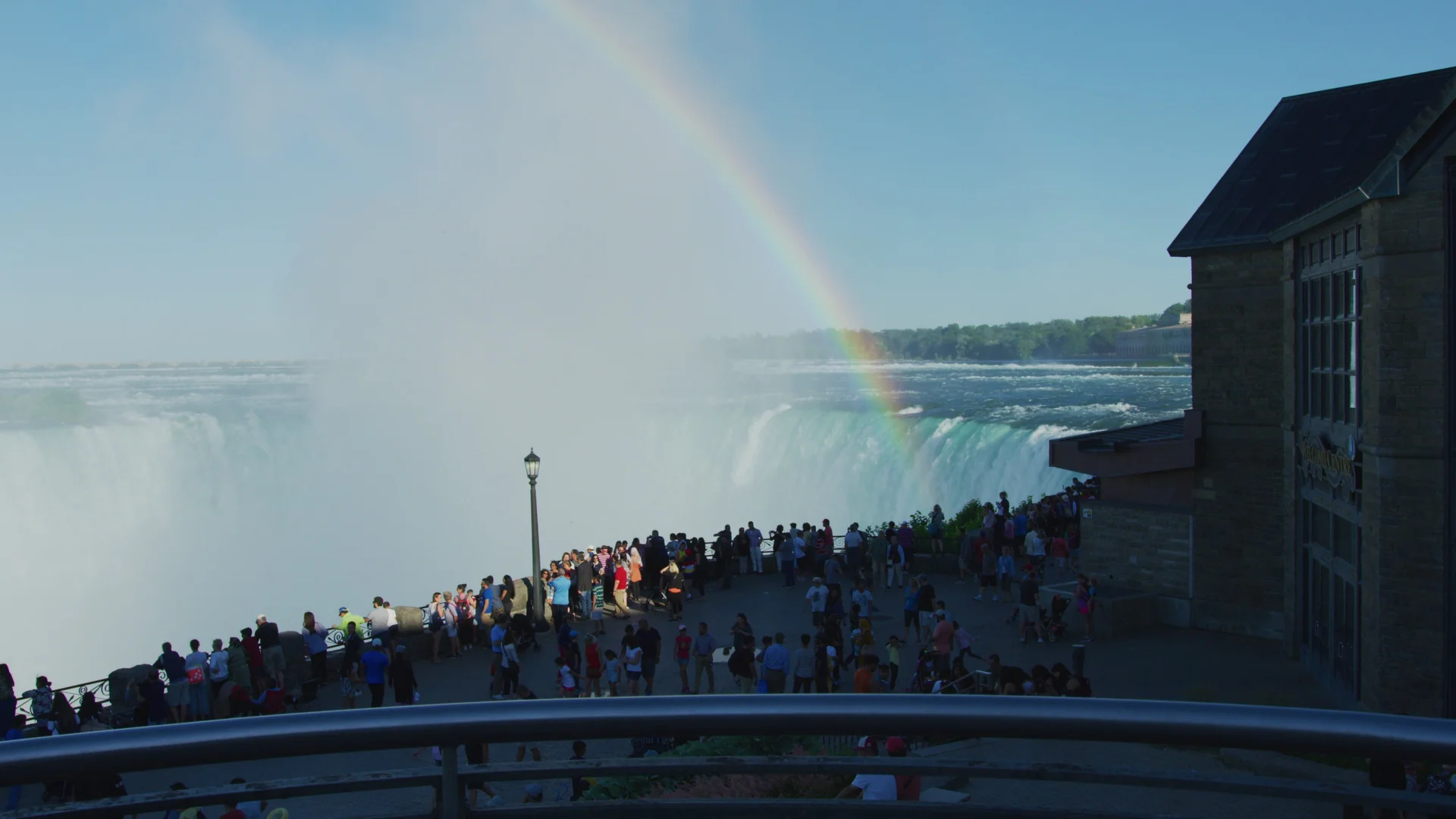 Rainbow over visitors beside Table Rock at Horseshoe Falls