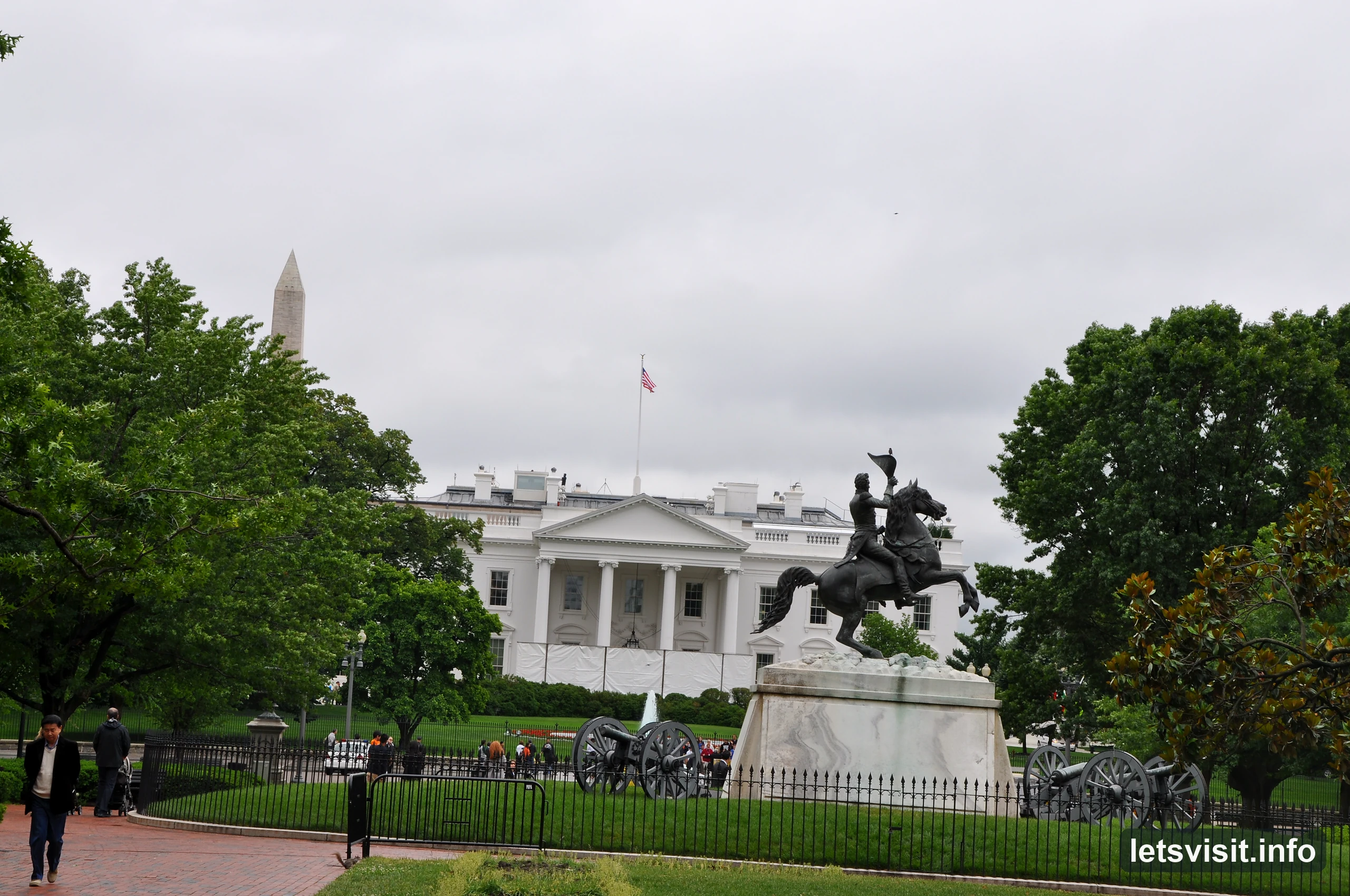Equestrian statue and leafy paths in Lafayette Square with the White House beyond