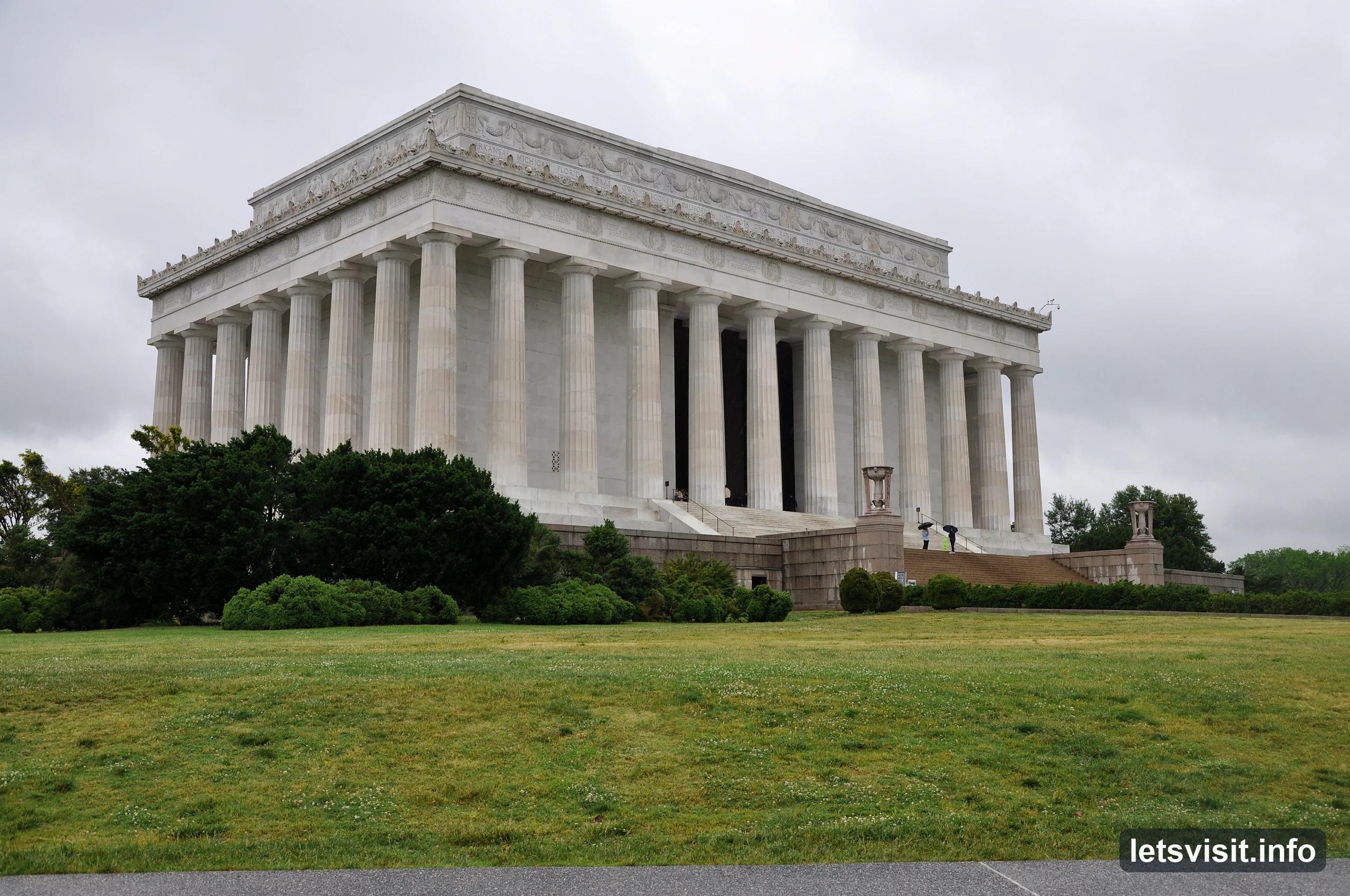 Lincoln Memorial columns above green lawns beneath an overcast sky