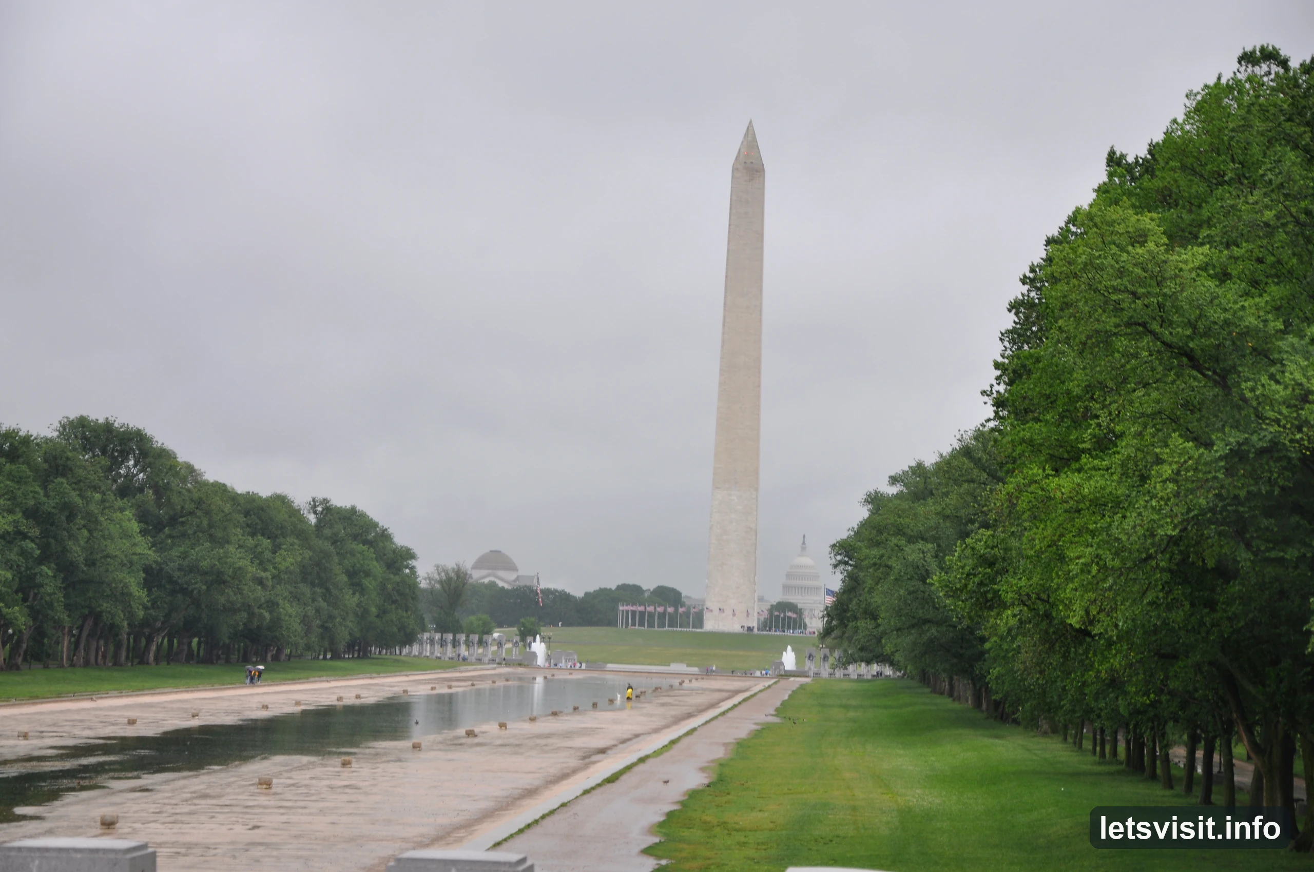 Washington Monument and the partly exposed Reflecting Pool beneath a grey sky